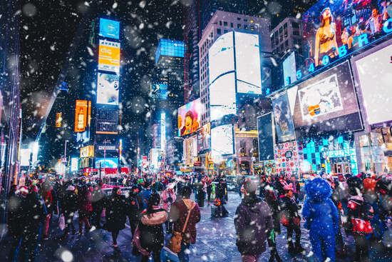 New York City, USA - March 18, 2017: People and famous led advertising panels in Times Square during snow, one of the symbol of New York City.