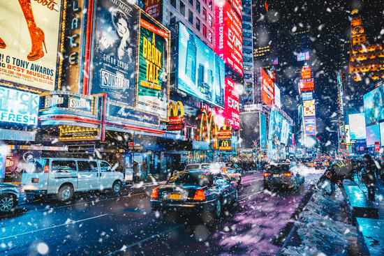 New York City, USA - March 18, 2017: People and famous led advertising panels in Times Square during snow, one of the symbol of New York City.